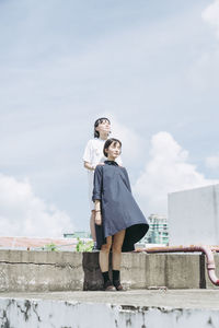 Portrait of young man standing against sky