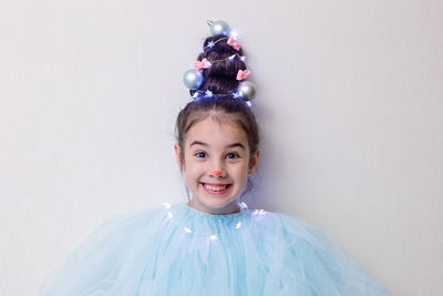 Funny girl with a hairstyle in the form of a christmas tree