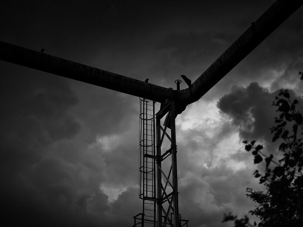 low angle view, sky, cloud - sky, cloudy, cloud, overcast, outdoors, weather, no people, tall - high, day, nature, development, power supply, construction, tall, engineering, pole, tranquility