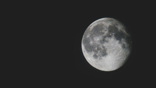 Low angle view of moon against sky at night