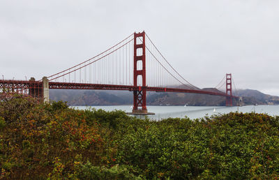 Golden gate bridge in city against sky