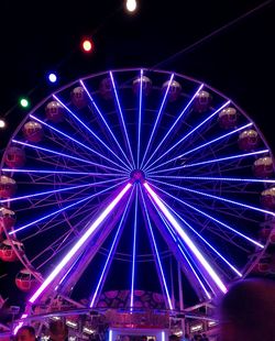 Low angle view of ferris wheel at night