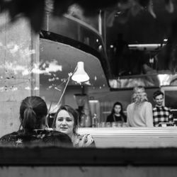 Portrait of woman with reflection in glass window