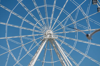 Full frame shot of ferris wheel against clear blue sky