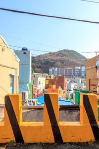 Buildings in city against clear sky