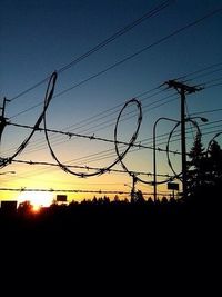 Silhouette of power lines at sunset