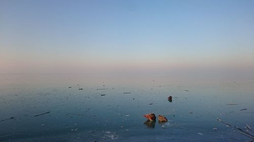Frozen high angle view of sea against sky during sunset