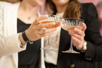 Midsection of woman holding drink