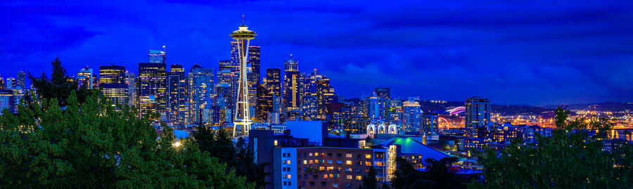 Illuminated cityscape against sky