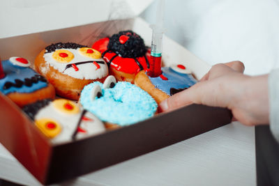 Cropped hand of woman holding christmas cookies