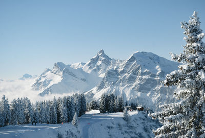 Scenic view of snow covered mountains against sky