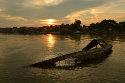 Scenic view of river against sky during sunset