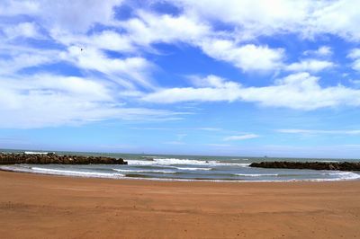 Scenic view of sea against cloudy sky