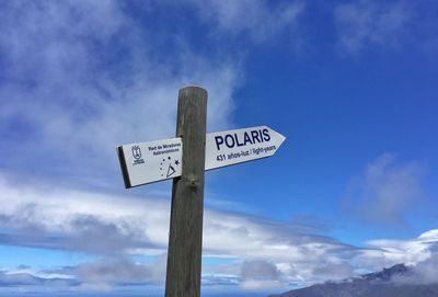 Low angle view of road sign against sky