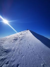 Scenic view of desert against clear blue sky