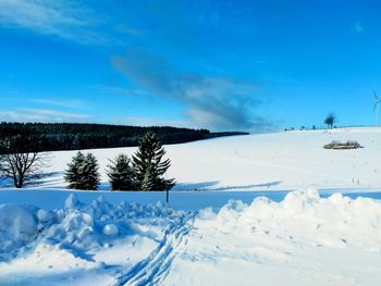 Snow covered field against sky