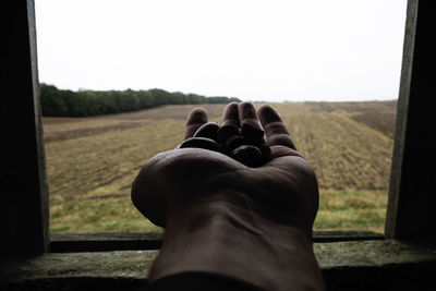 Low section of man wearing shoes against clear sky