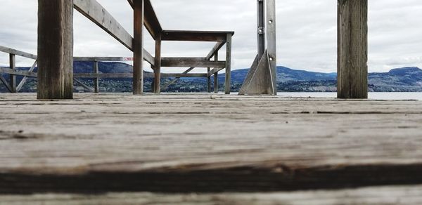 Wooden pier on beach against sky