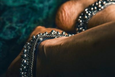 Close-up of woman wearing anklets