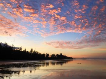 Scenic view of lake against orange sky