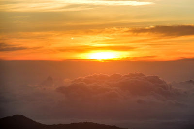 Scenic view of silhouette mountains against romantic sky at sunset
