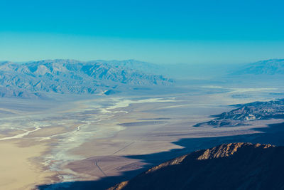 Scenic view of mountains against blue sky