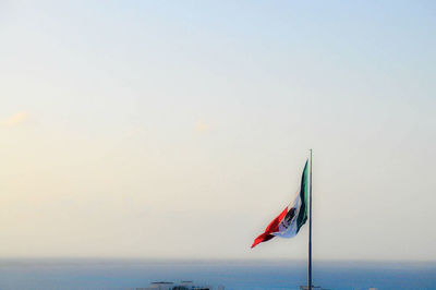 Flag against sky at sea