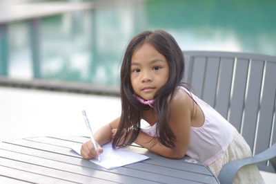 Portrait of a girl sitting on table