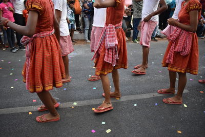 Low section of people dancing on street