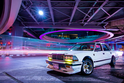 Digital composite image of light trails on road at night