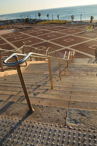High angle view of empty chairs on beach
