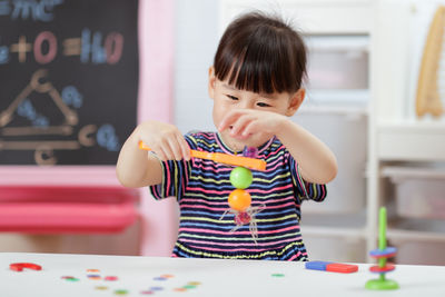 Young girl play magical magnet experiments at home for homeschooling