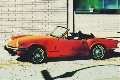 Vintage car on street against wall