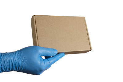 Close-up of hand holding umbrella against white background