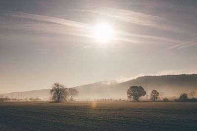 Scenic view of field against sky during foggy weather