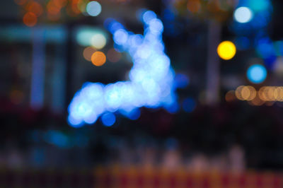 Defocused image of illuminated city at night