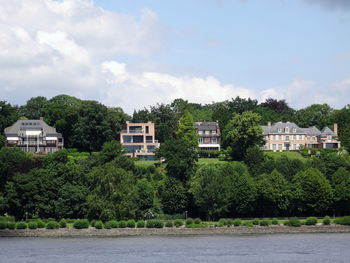 Houses against cloudy sky