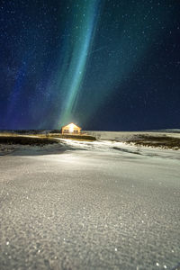 Scenic view of snow against sky at night