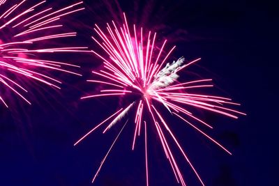 Low angle view of firework display at night