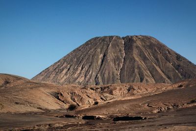 View of volcanic mountain against blue sky