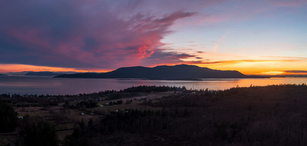 Sunset over orcas island. the clouds remind me of a dragon emerging from behind the island.