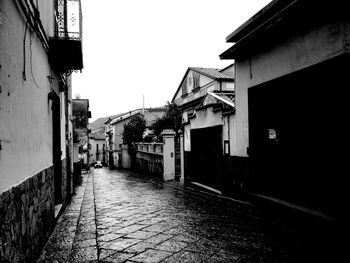 Street amidst houses against sky