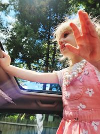 Portrait of young woman sitting in car
