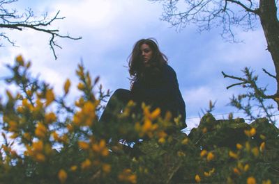 Low angle view of woman against sky