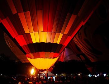 Low angle view of illuminated lights at night