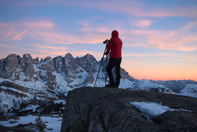 Rear view of man standing on wild mountain against sky  - alps, dolomities, pale di san martino