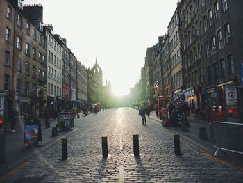 People on street in city against clear sky