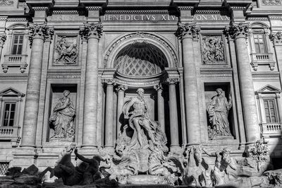 Statue against historic building