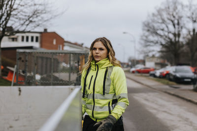 Portrait of young female road worker