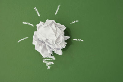 Close-up of paper flowers against green background